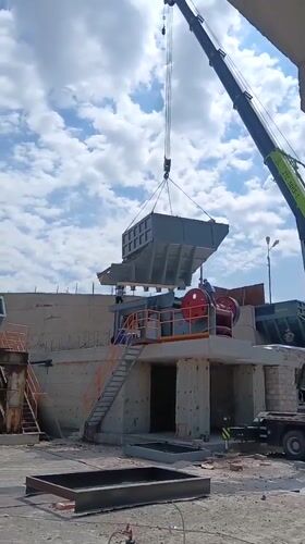 Crane sets hopper onto stone crusher at Armenian industrial site