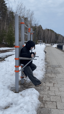 Person exercises on outdoor equipment in Chaykovsky, Russia