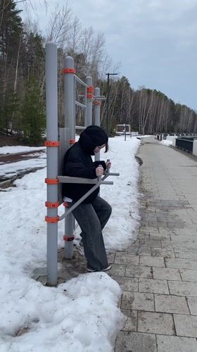 Person exercises on outdoor equipment in Chaykovsky, Russia