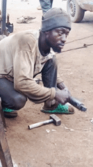 Auto mechanics work at informal roadside workshop in Nigeria