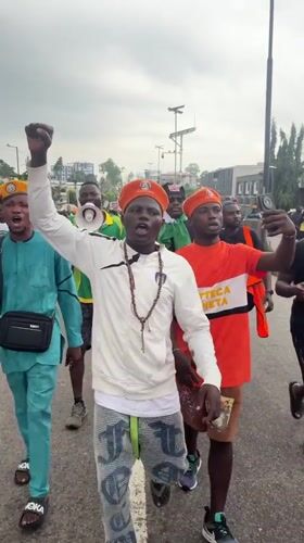 Young men march in Ikeja wearing "Bring Back Our Children" message
