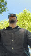 Man in sunglasses observed outdoors in sunny London