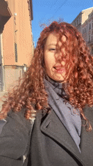 Woman records selfie video outdoors in sunny Saint Petersburg