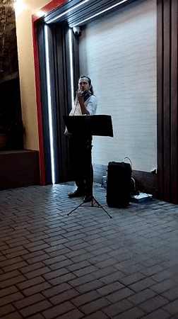 Violin performance outside a modern building in Bender, Moldova