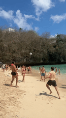 Crowded Kuta Selatan beach, with a traditional offering on the sand