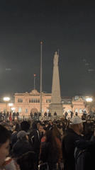 Nighttime crowd gathers near Casa Rosada in Buenos Aires