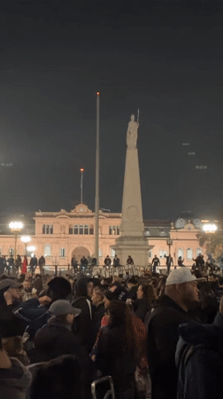 Nighttime crowd gathers near Casa Rosada in Buenos Aires
