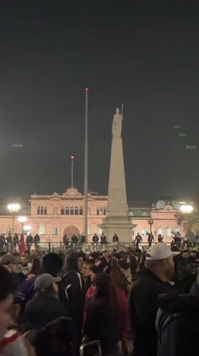 Nighttime crowd gathers near Casa Rosada in Buenos Aires