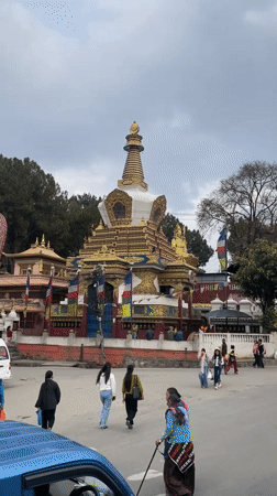 Buddhist stupa documented in Kathmandu under overcast skies
