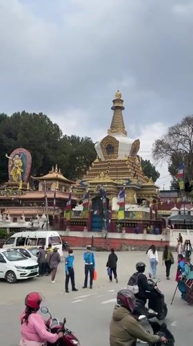 Buddhist stupa documented in Kathmandu under overcast skies