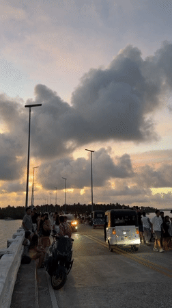 Sunset gathering draws crowds to General Luna bridge