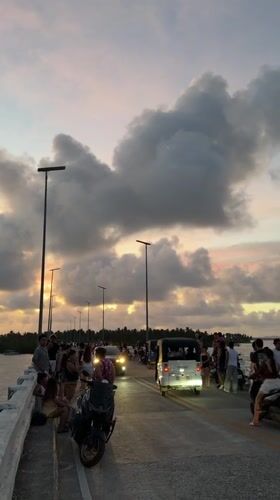 Sunset gathering draws crowds to General Luna bridge