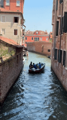 Canal traffic and street scenes through Venice on a summer morning