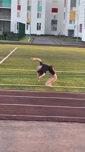 Girl performs backbend on athletic field in Saratov
