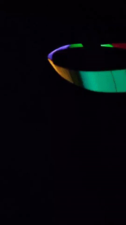 Person plays with colorful light accessories in Chelyabinsk evening