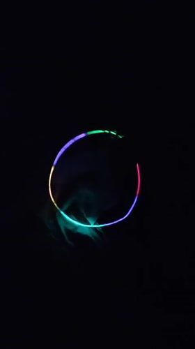 Person plays with colorful light accessories in Chelyabinsk evening