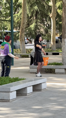 Women practice dance and Tai Chi in Chinese park