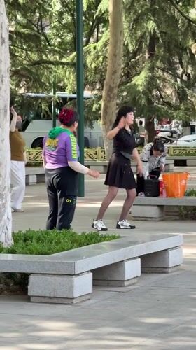Women practice dance and Tai Chi in Chinese park