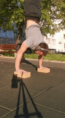 Person performs handstand on blocks at Burgas playground