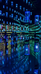 Illuminated cylindrical art installation creates reflective display in Dubai