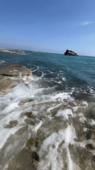Rusted shipwreck off Akrotiri's rocky shore, Cyprus
