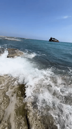 Rusted shipwreck off Akrotiri's rocky shore, Cyprus
