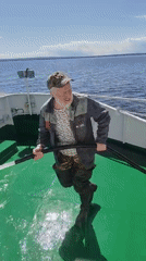 Man operates water gun on boat deck in Russia