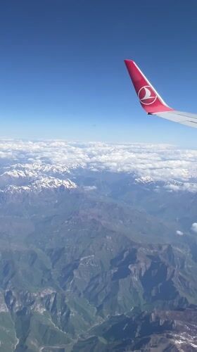 Turkish Airlines passenger films mountain views over Montenegro