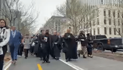 Religious procession with wooden cross observed on NYC street