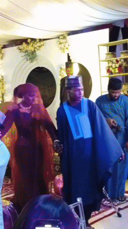 Wedding ceremony with traditional attire observed in decorated hall