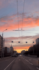 Krasnoyarsk resident documents colorful skies, resting Pomeranian dog