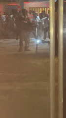 Security personnel gather in lit area at night