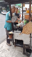 Street food cart in full swing on a Semarang sidewalk