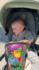 Baby plays jungle drum in stroller, Tel Aviv