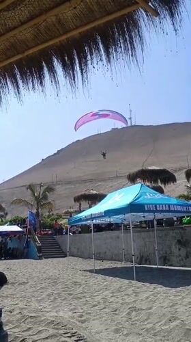 Paragliders soar over Arica's sunny coastal beach
