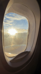 Passenger captures sunlit view from aircraft window over Tbilisi