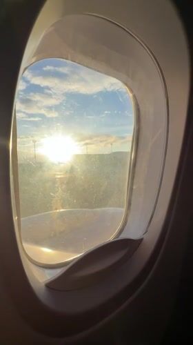 Passenger captures sunlit view from aircraft window over Tbilisi