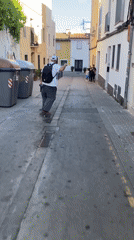 Skateboarder navigates narrow street in Badalona, Spain