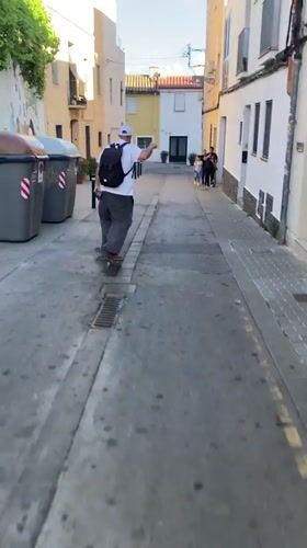 Skateboarder navigates narrow street in Badalona, Spain