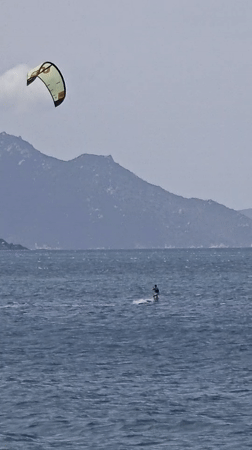 Morning beach scene with kitesurfing and leisure activities in Nha Trang