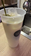 Green liquid poured into iced white drink in Moscow