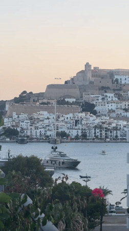 Rooftop evening in Ibiza with harbor views and golden sunset