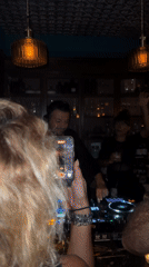 DJ performs at crowded bar in Baan Bang Rak