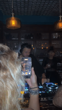 DJ performs at crowded bar in Baan Bang Rak