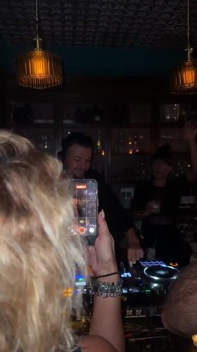 DJ performs at crowded bar in Baan Bang Rak