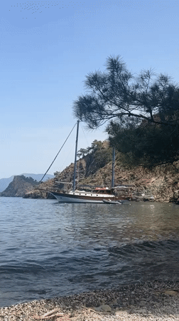 Two-masted sailboat anchored in Fethiye bay on sunny morning