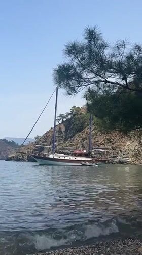 Two-masted sailboat anchored in Fethiye bay on sunny morning