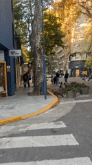 Pedestrians observed on Buenos Aires street corner during sunny evening