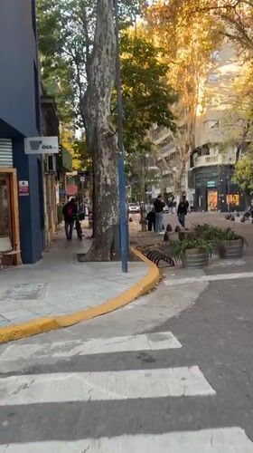 Pedestrians observed on Buenos Aires street corner during sunny evening