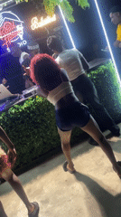 Nighttime outdoor club gathering with dancing and DJ entertainment